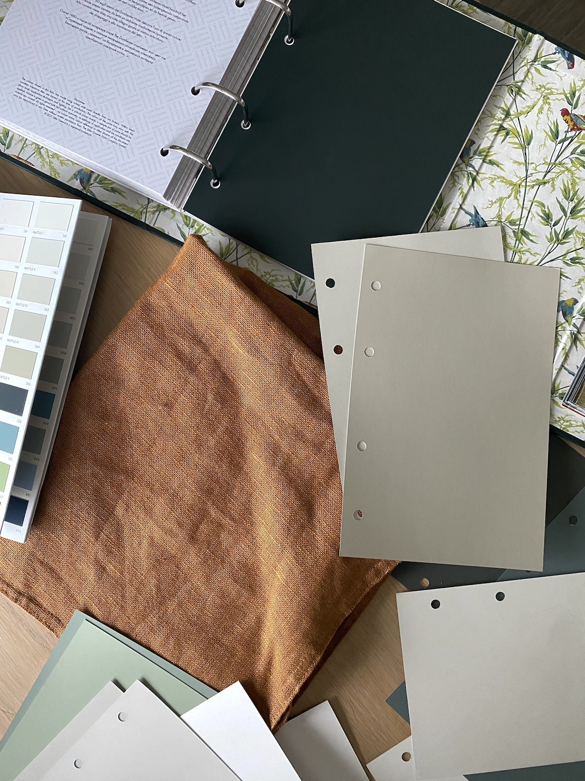 Paint cards, fabric and wallpaper arranged for a colour consultation.